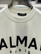 Balmain - Paris Logo Print Cotton T-Shirt in Off-White with Black Raised Lettering